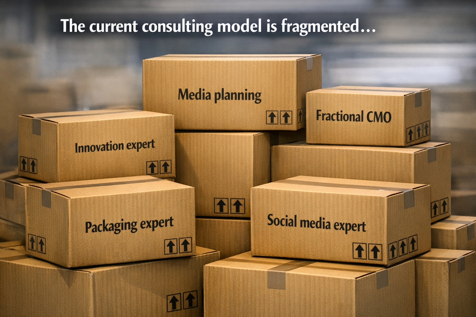 Stacks of cardboard boxes labeled with various marketing roles such as 'Innovation expert', 'Media planning', 'Fractional CMO', 'Packaging expert', and 'Social media expert'. The boxes are arranged on a table against a blurred background, with the text 'The current consulting model is fragmented...' at the top
