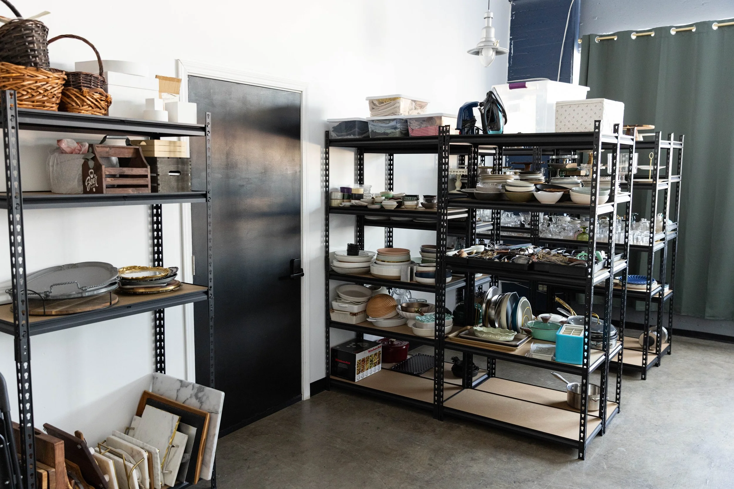 Props room with multiple shelves of dishes available for use with food photography studio rentals.