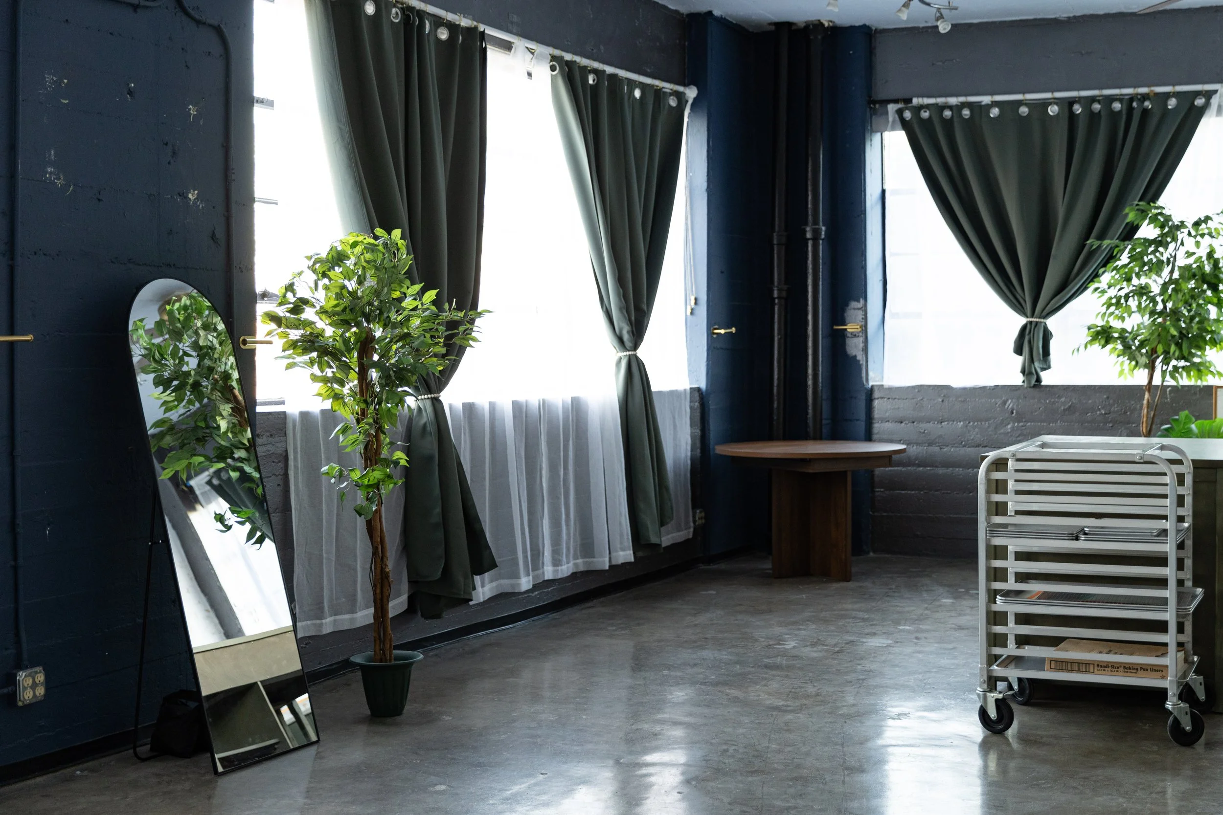 Large windows draped with curtains in Los Angeles food photography studio.