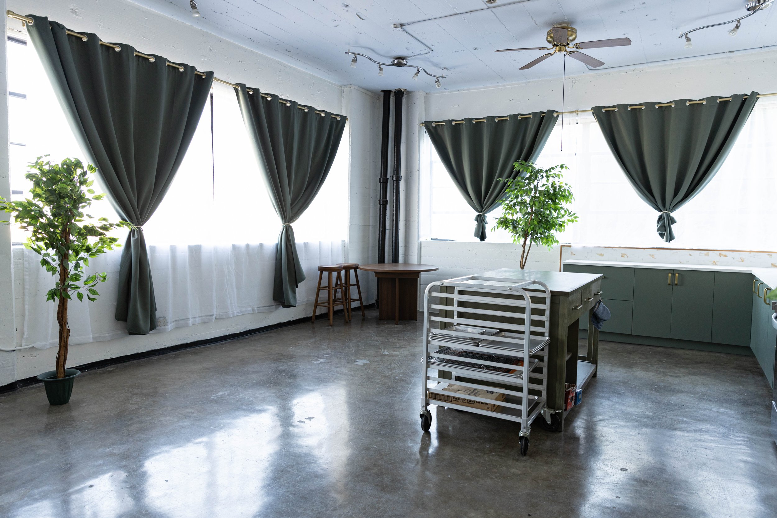 Large windows draped with curtains in Los Angeles food photography studio.
