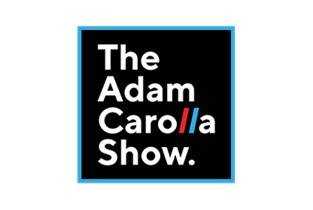 Logo for the Adam Carolla Show with white text on a black background and a blue border.