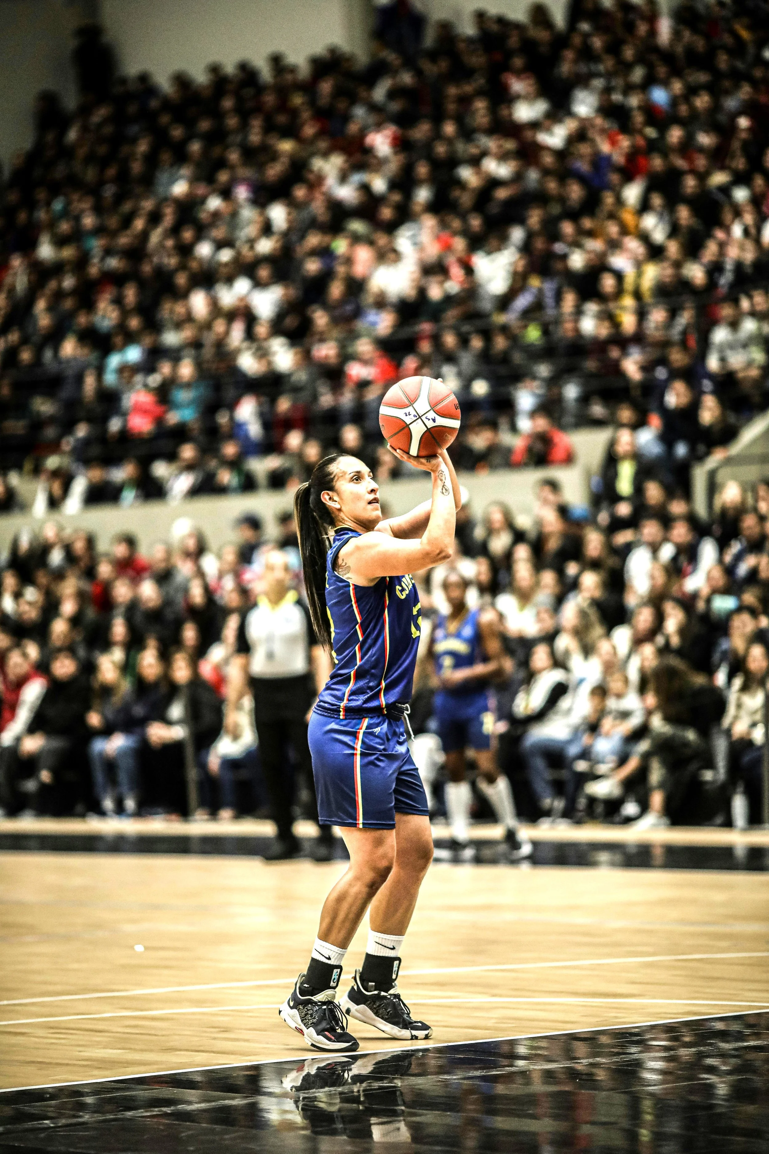 A woman playing basketball shooting a free throw