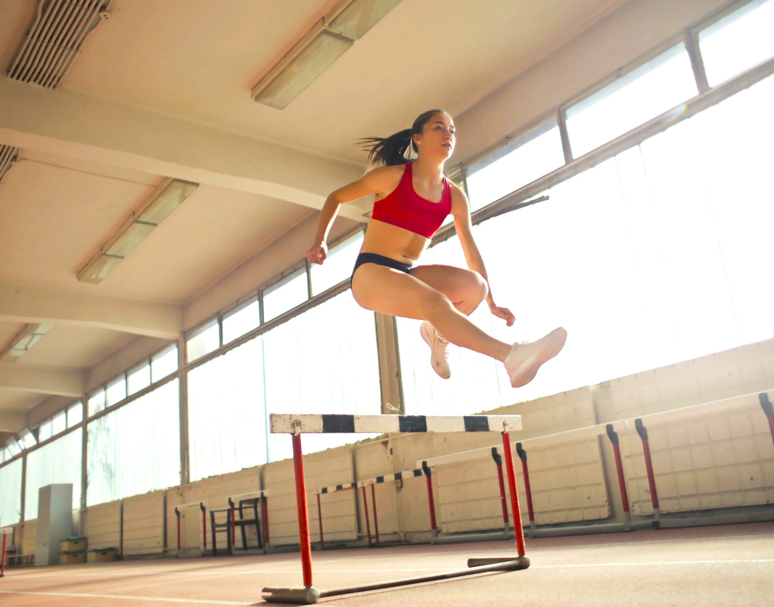 A woman hurdling in a track competition