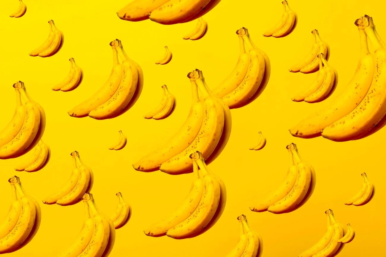 Bananas sitting on a yellow background