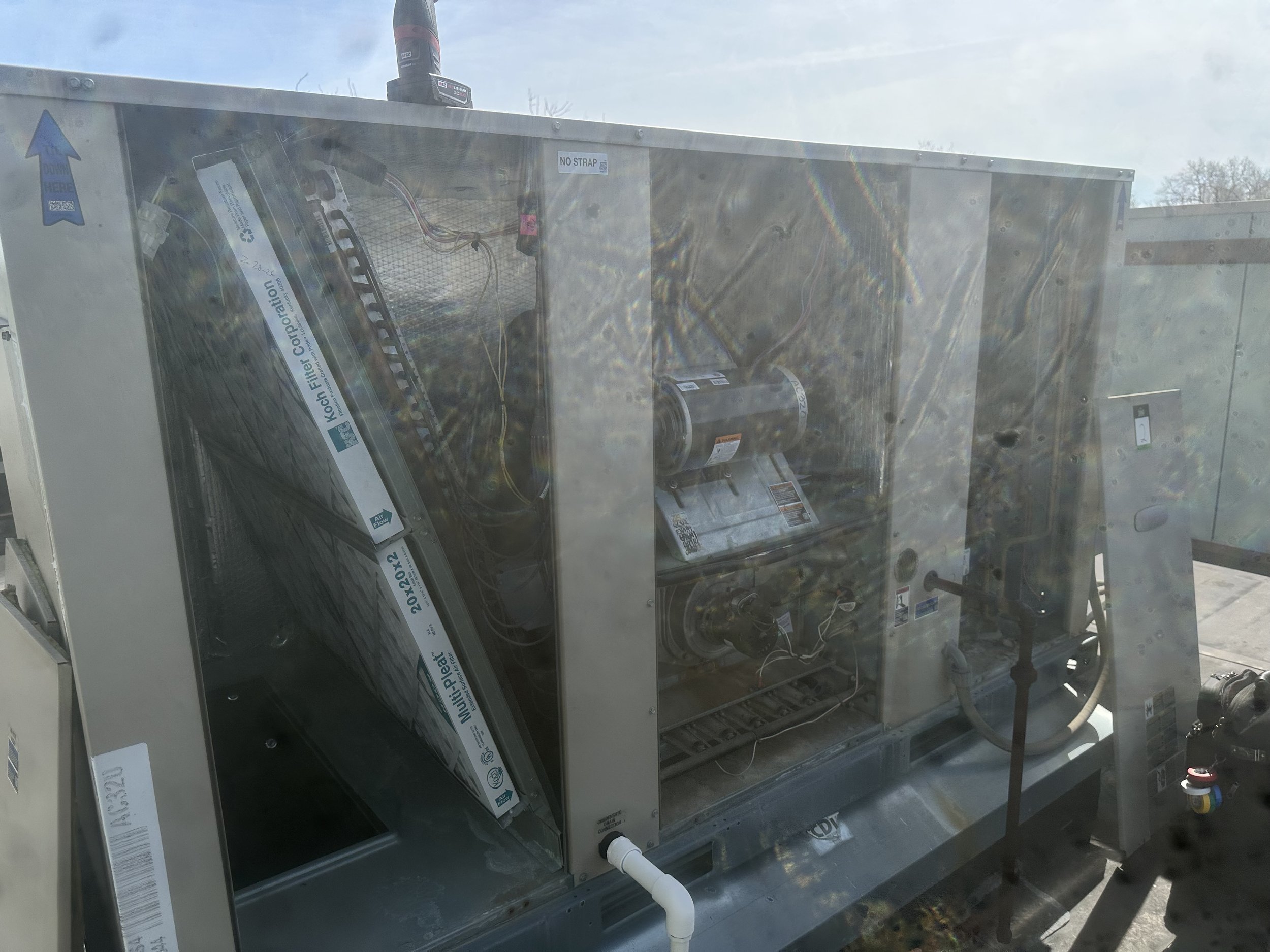 The image shows an industrial or commercial refrigeration unit, with internal components visible through a transparent panel, including coils, wiring, and mechanical parts.