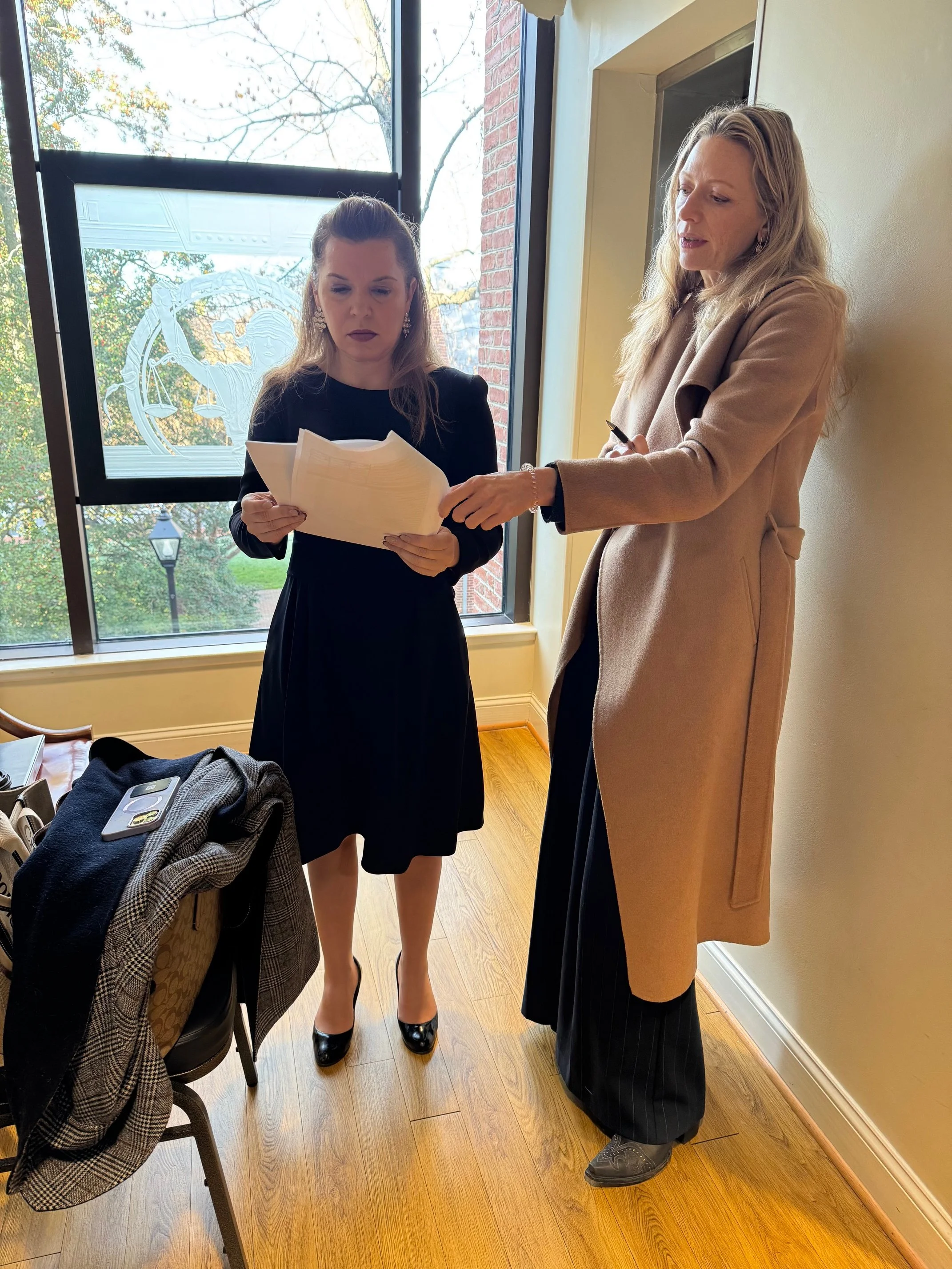 Katerina Minevich, Certified Divorce Financial Analyst®, reviewing financial documents with a family law attorney during the divorce process.