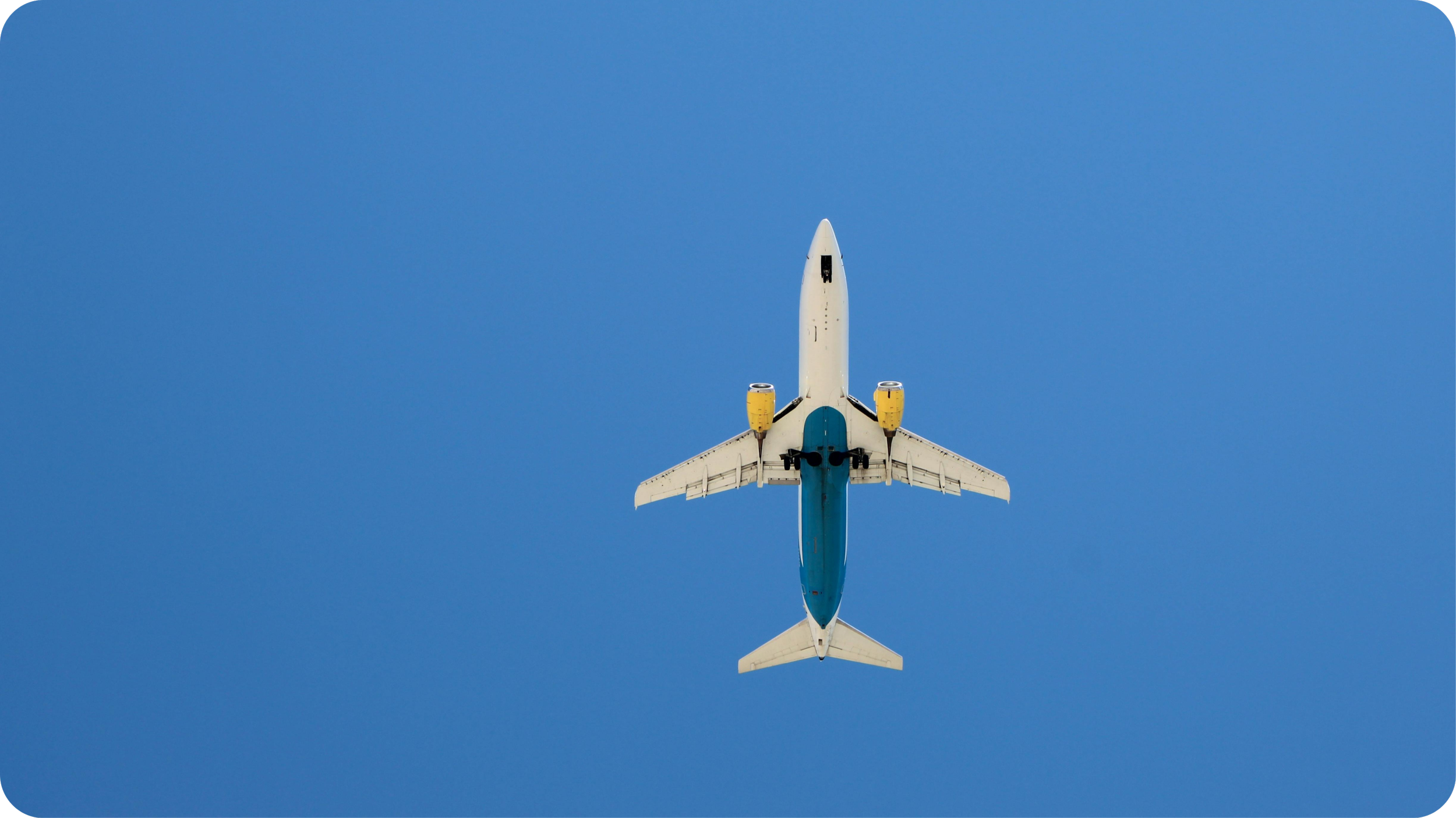 An airplane flying in clear blue sky seen from below.