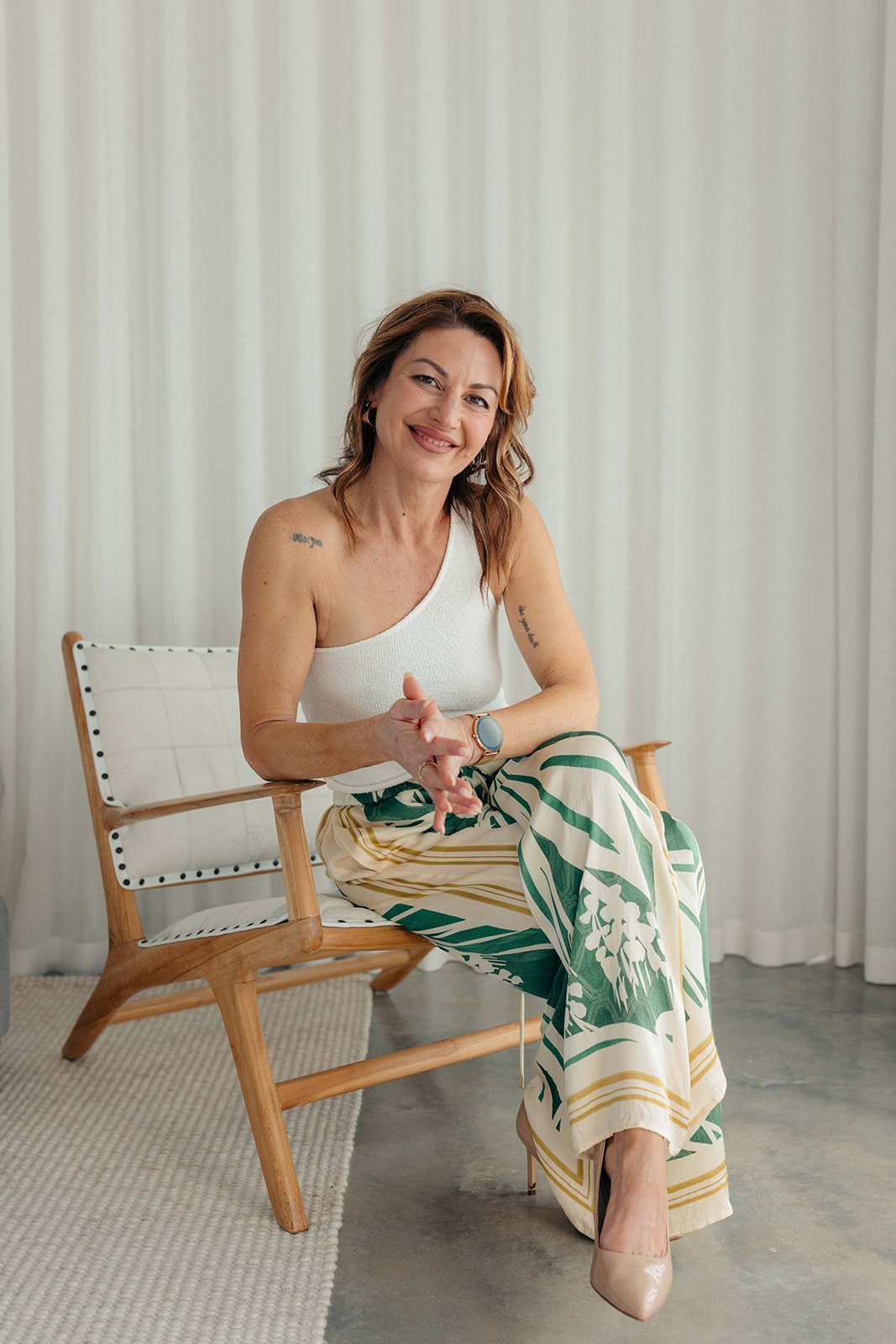 Tee, founder of Your Velvet Passport, seated and smiling