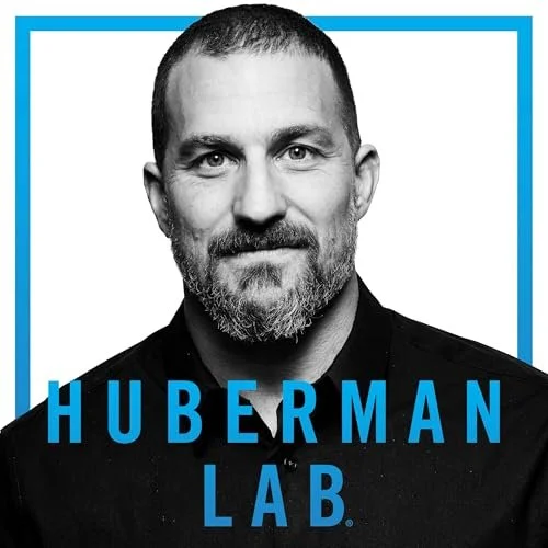 Black and white photo of a man with short hair and beard, smiling, with the text 'Huberman Lab' in blue below the photo, and a blue border around the image.