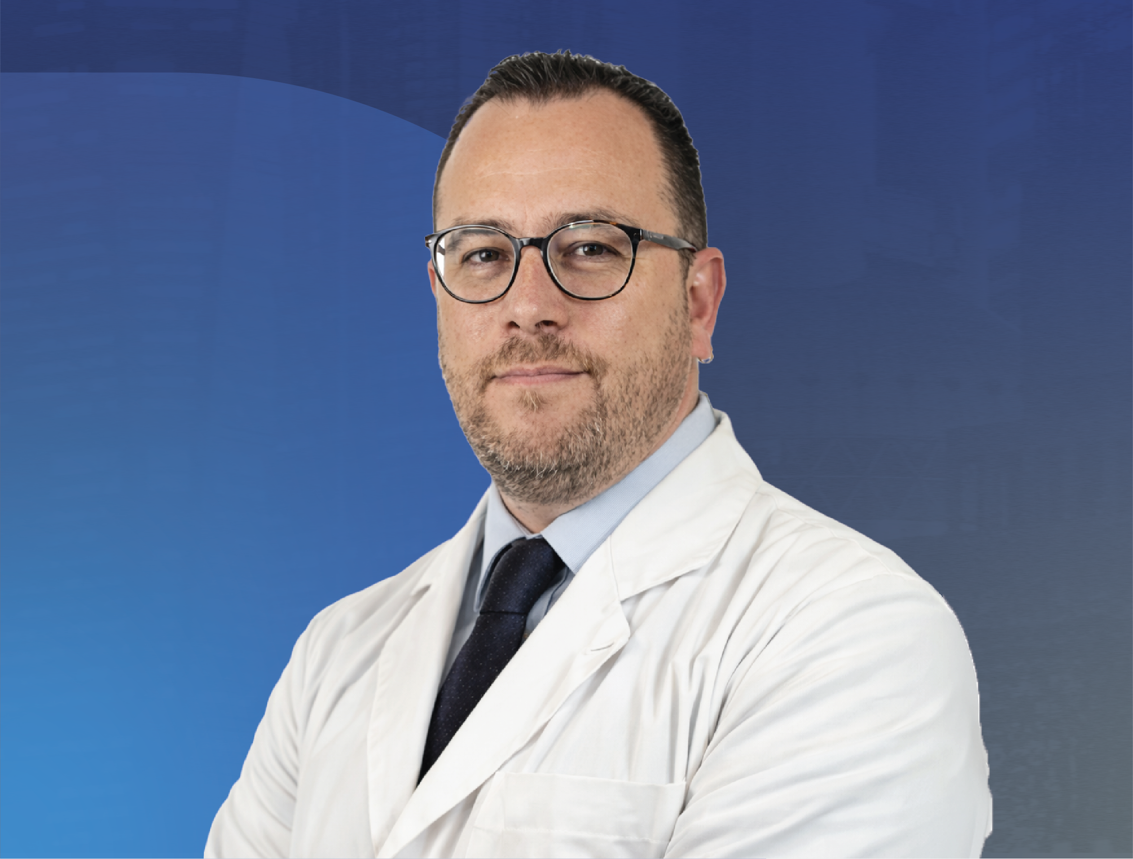 Professional portrait of Dr Arturo Picchardo from Teleton in a white lab coat and glasses posing against a blue background.