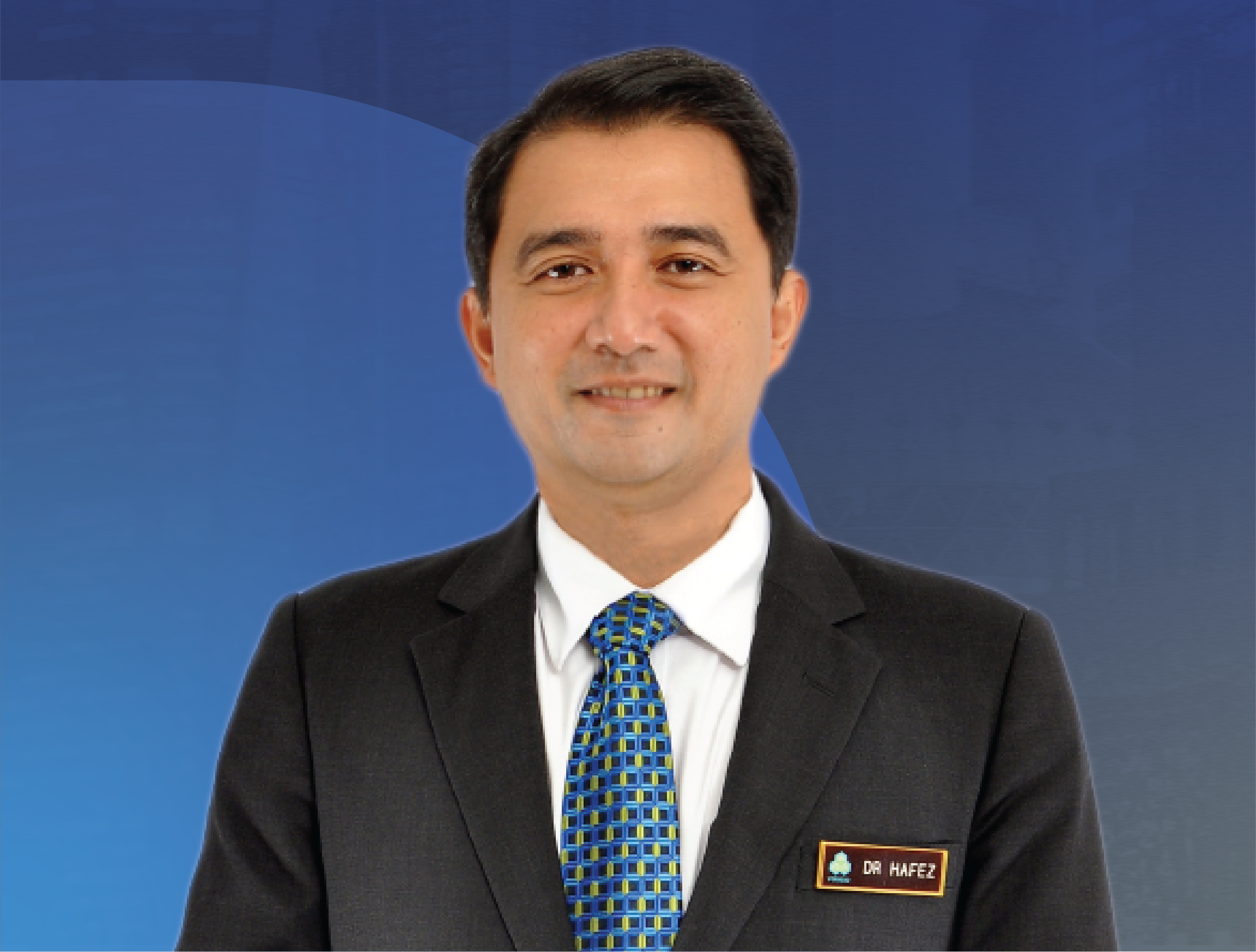 Professional headshot of Datuk Dr. Hafez Hussain from PERKESO Malaysia in a business suit with a name tag, smiling, in front of a blue background.