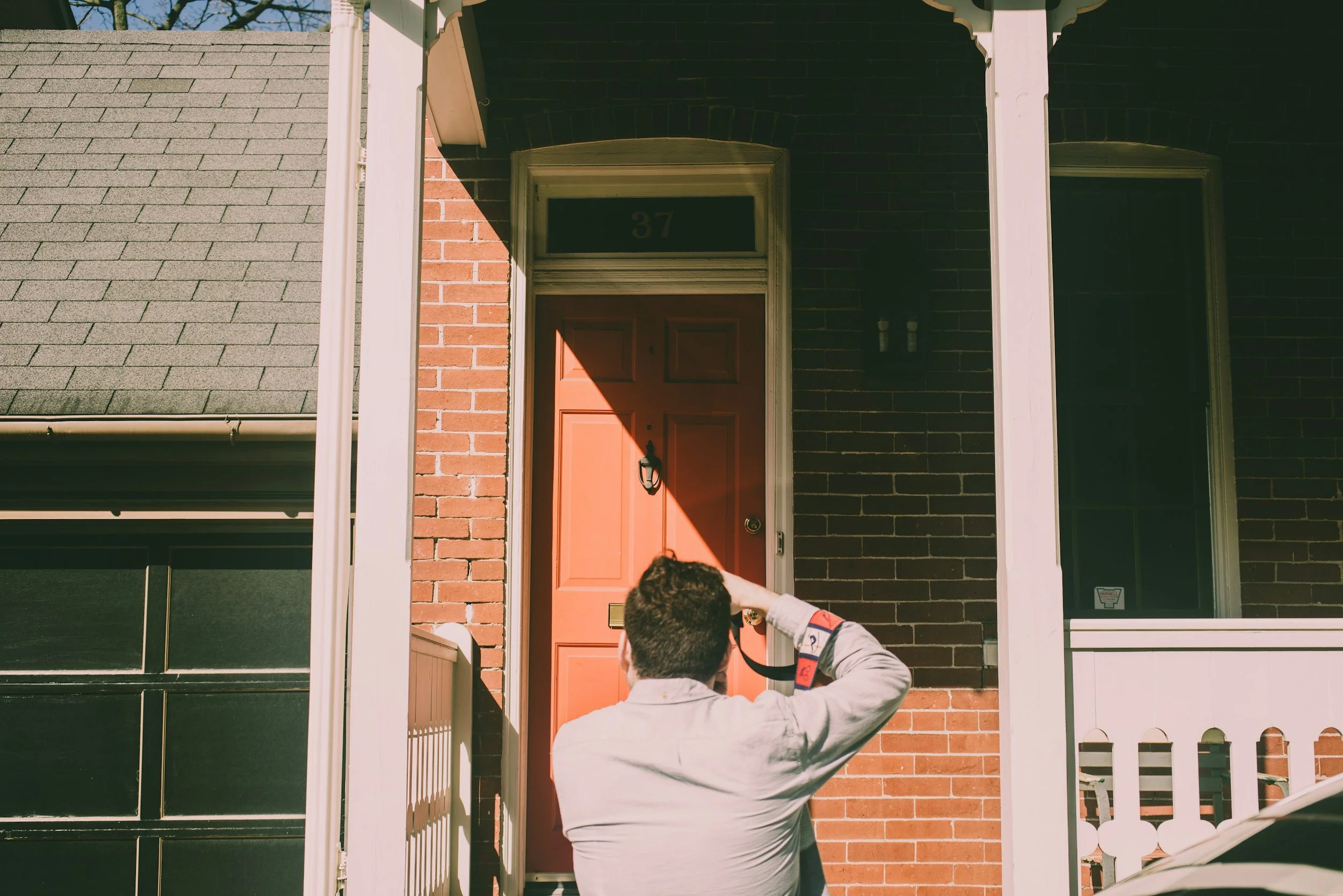 A man taking a photo of a house as he is conducting a thorough home inspection as part of the home buying process in Greater Los Angeles