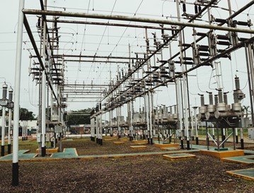 Electric power substation with numerous electrical transformers and circuit breakers.
