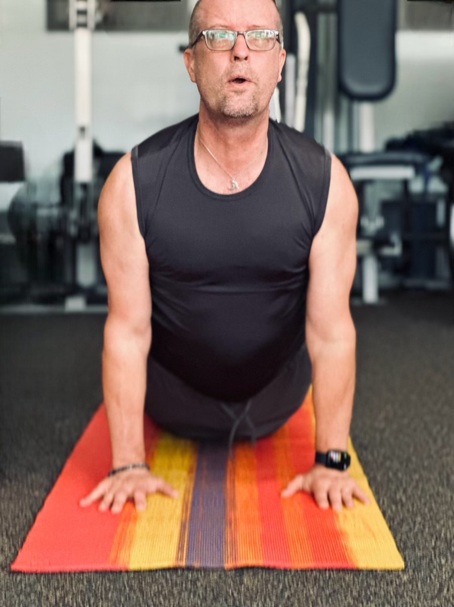 Bill Rodowsky, PTA demonstrating yoga cobra pose for back pain relief.