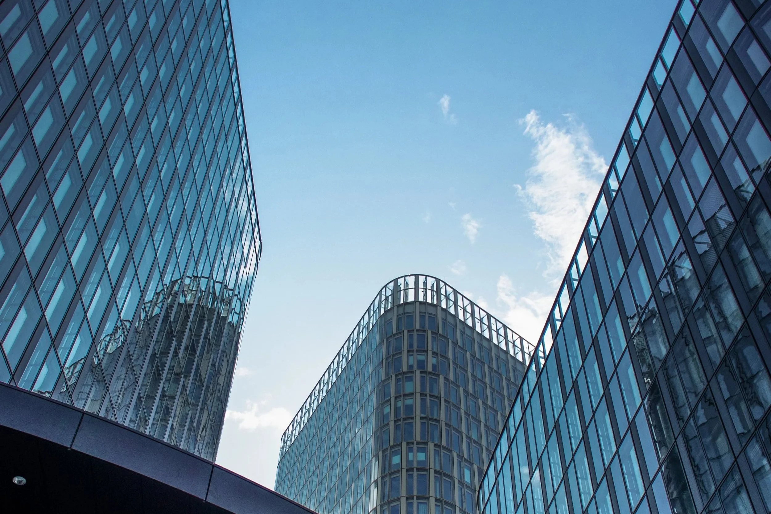 vertical-shot-modern-office-buildings-with-big-reflective-windows-sunlight.jpg