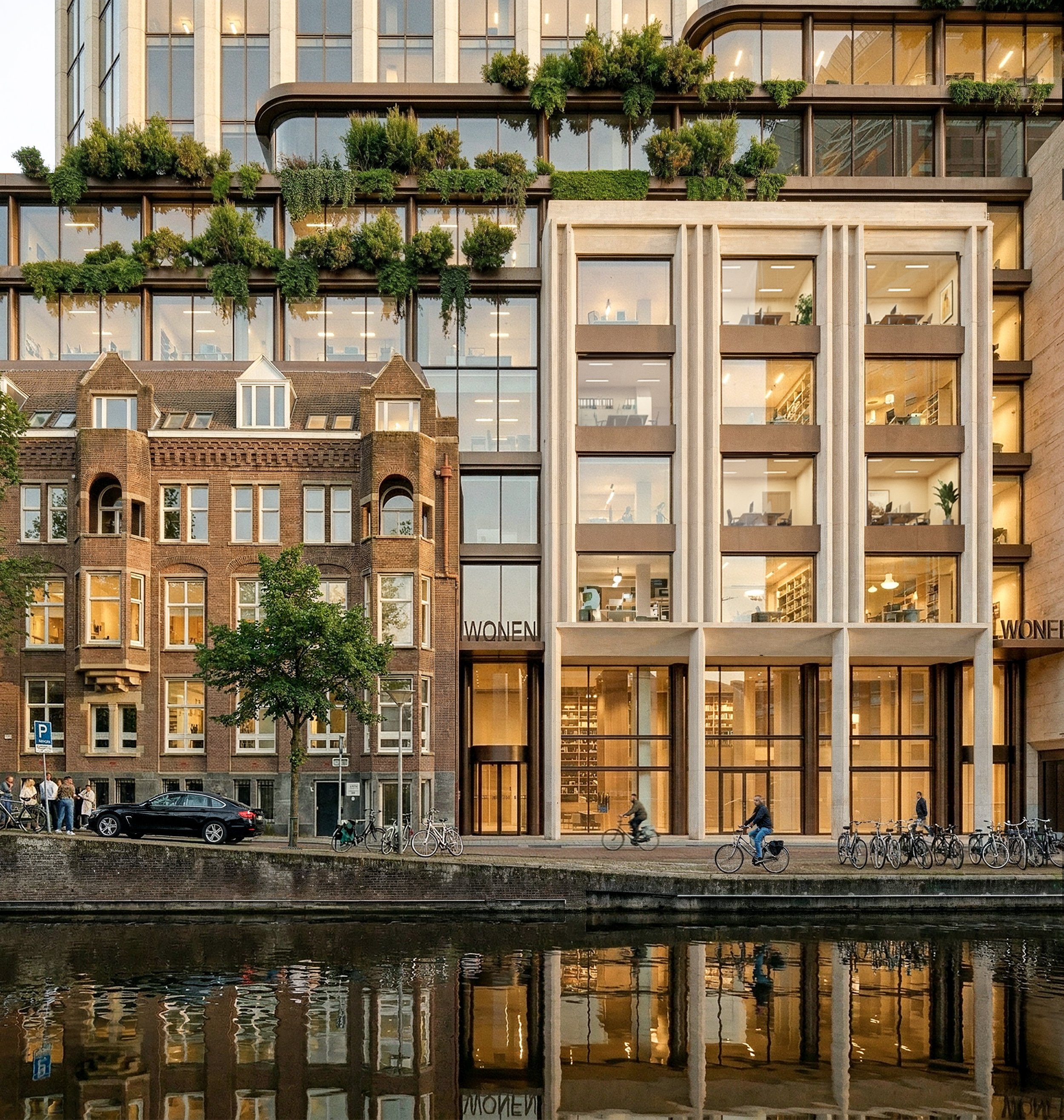 Modern multi-story building with large glass windows, greenery on the upper floors, and a sign reading 'WOMEN' near the entrance; a canal with reflections in the foreground, bicycles, and pedestrians walking or cycling along the street.