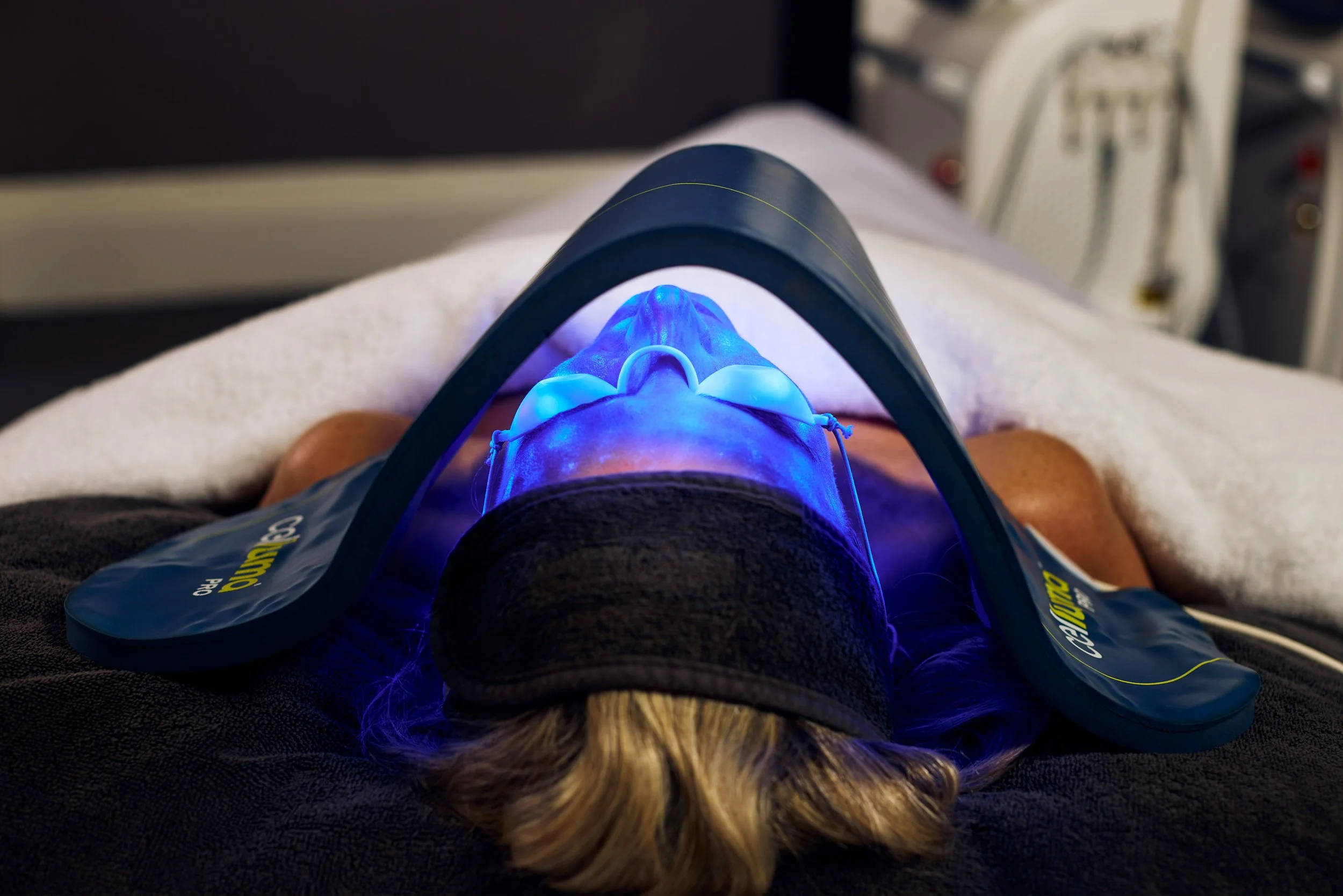 Person receiving a dental teeth whitening treatment using a blue LED curing light.