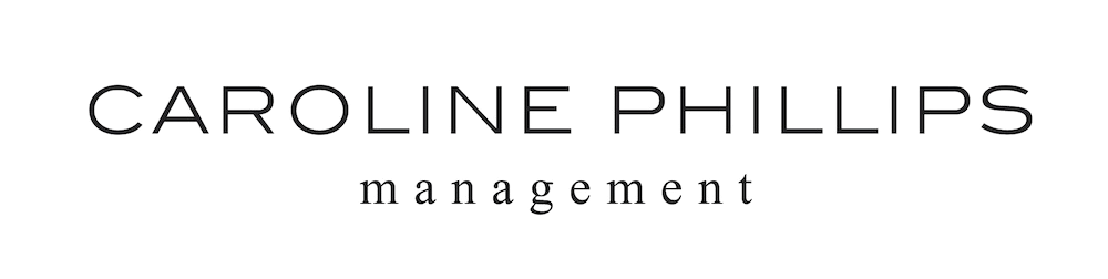 Black business card with silver text saying 'CAROLINE PHILLIPS management'