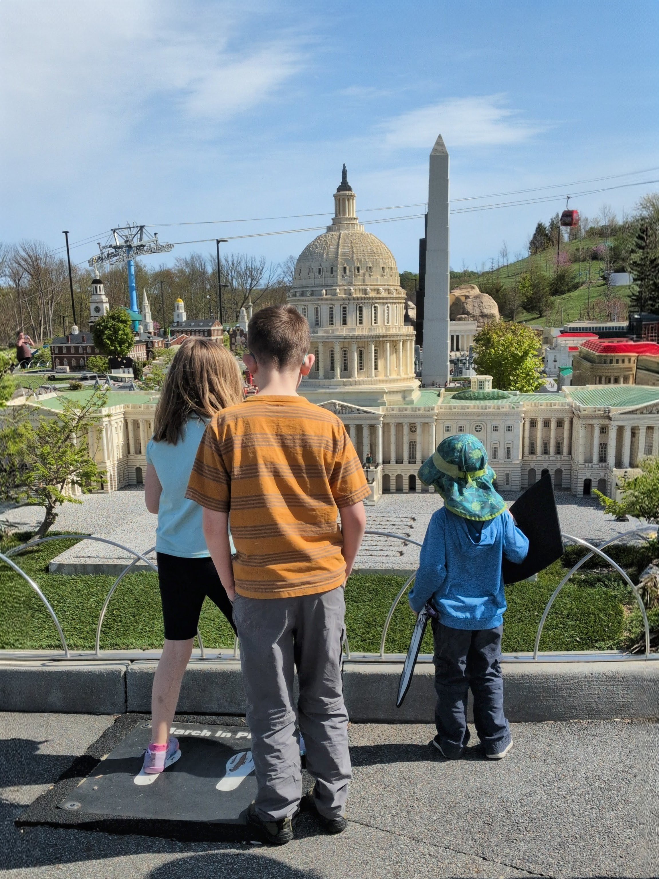 Three kids standing in front of the LEGO Capital Building at LEGOland NY