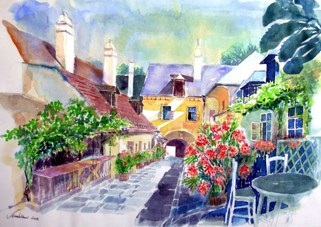 A watercolor painting of a charming European village street with colorful buildings, plants, and outdoor furniture.