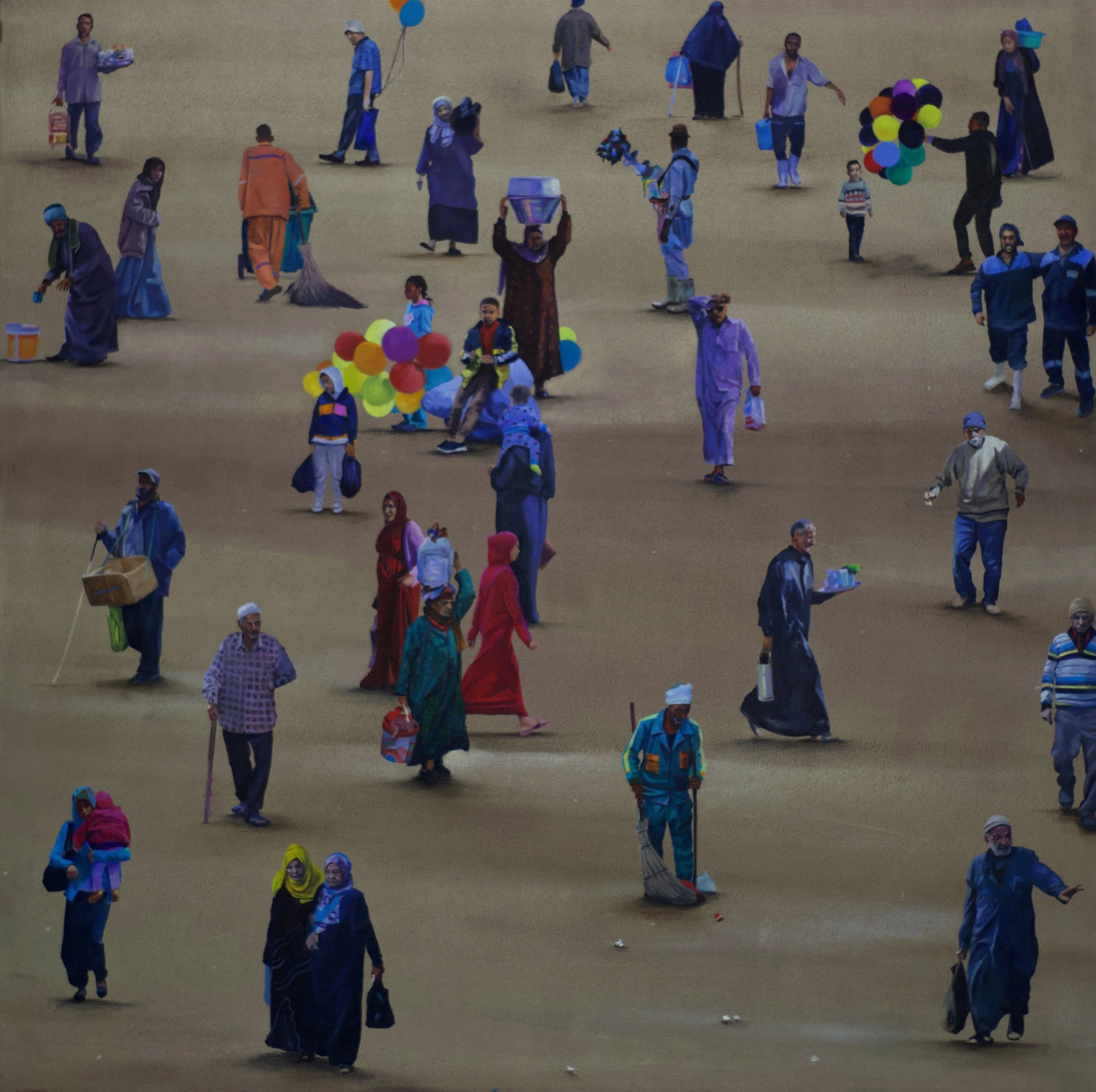 Multiple people walking and carrying balloons, bags, and tools on a large, open, sandy area.