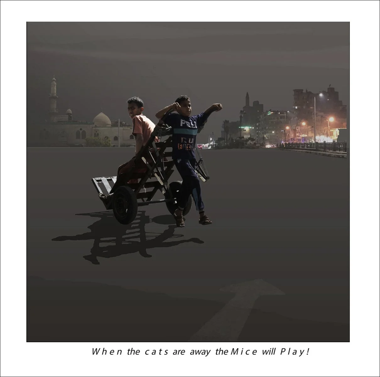 Two children playing on a makeshift cart in an urban area at night, with city lights and buildings in the background.