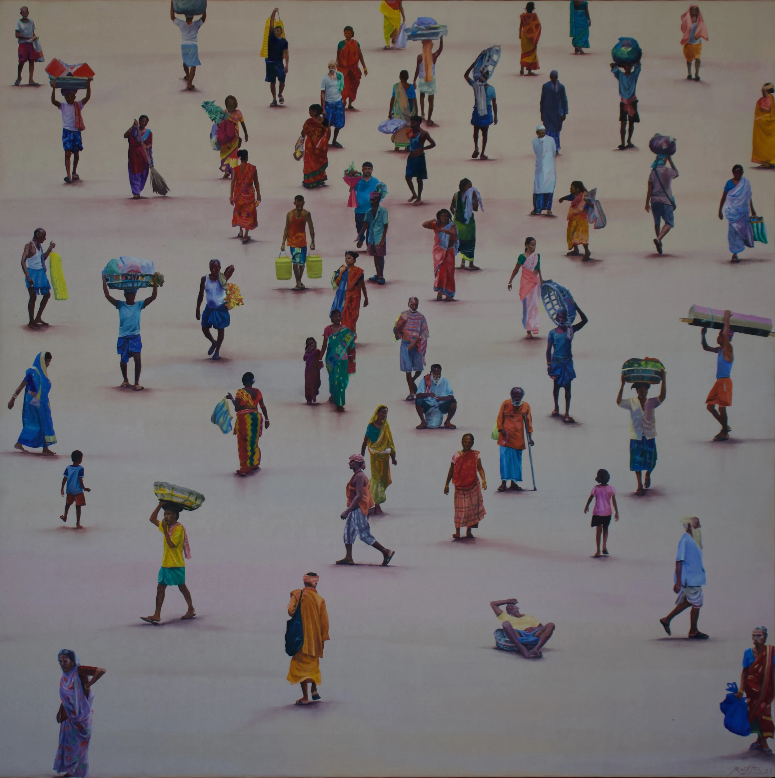 A large crowd of people, mostly women and children, walking across a sandy or dusty open area. Many are wearing colorful traditional clothing and carrying items such as baskets, bags, or bundles on their heads. The scene appears to be in a rural or semi-rural setting.