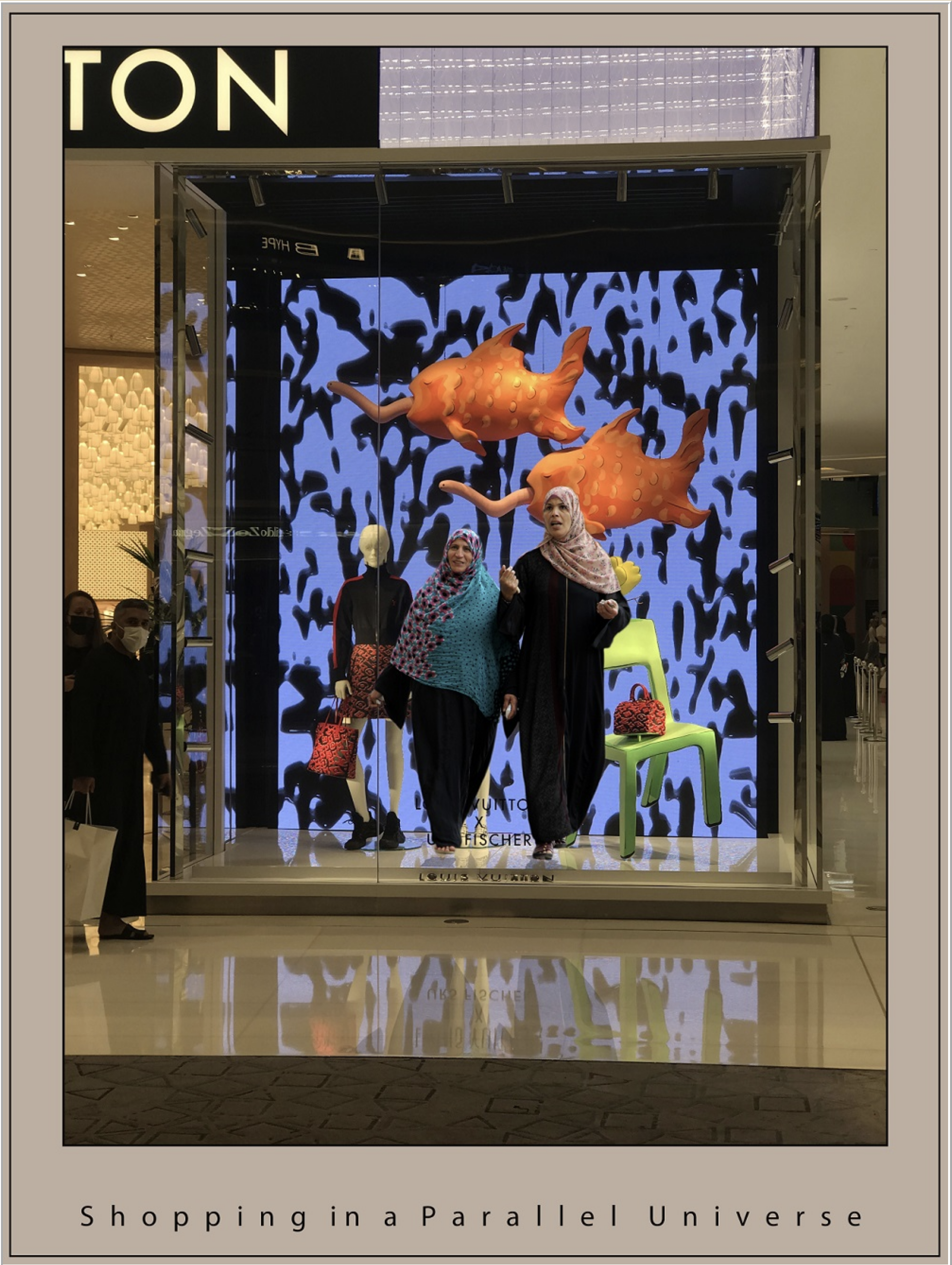 People shopping in a virtual store display with a backdrop that features two orange fish, creating a scene that appears to be underwater, with the words "Shopping in a Parallel Universe" written at the bottom.