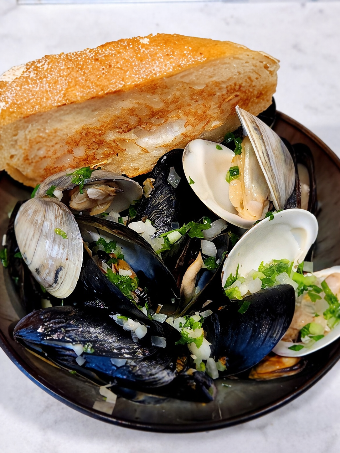 Mussels and clams with toasted bread.png