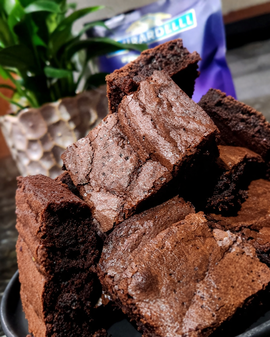 Decadent chocolate brownies on dark plate.png