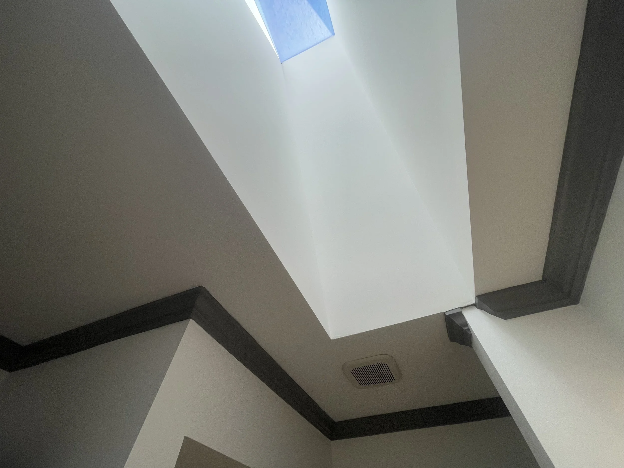 Angular architecture highlighted with gray trim and bright white walls.