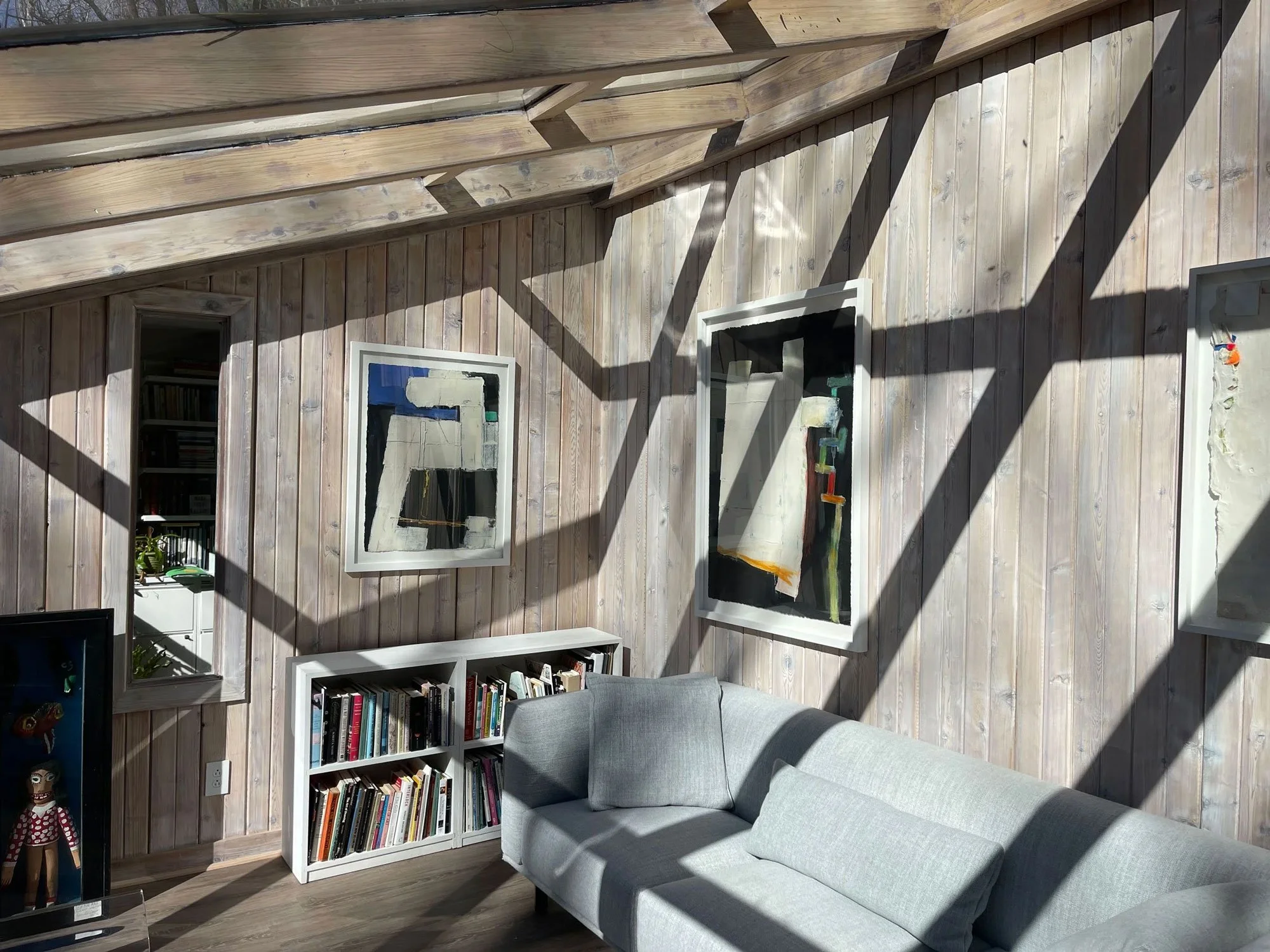 A cozy 1970's sunroom re-styled to modernize and brighten the sunlit enclosed porch.