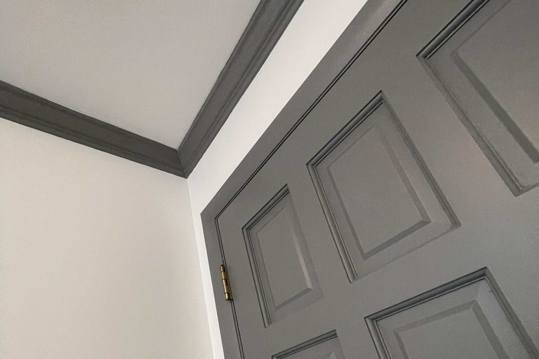 Alternative styling can transform a simple room. Gray crown molding, trim, doors and windows set against white walls modernizes a normal room.