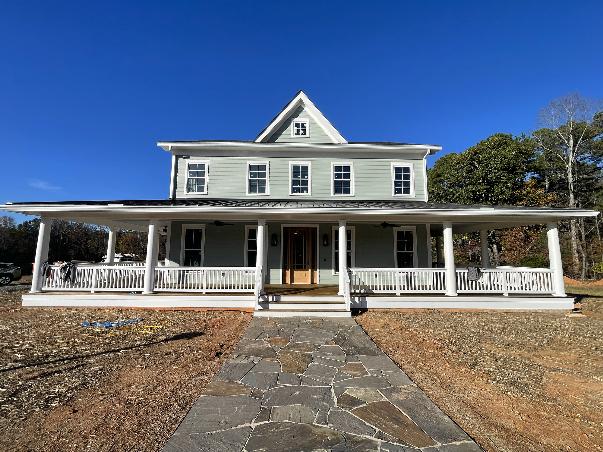 A new construction home in Hurdle Mills - front view. A two-story house with a 1500 square feet covered porch.