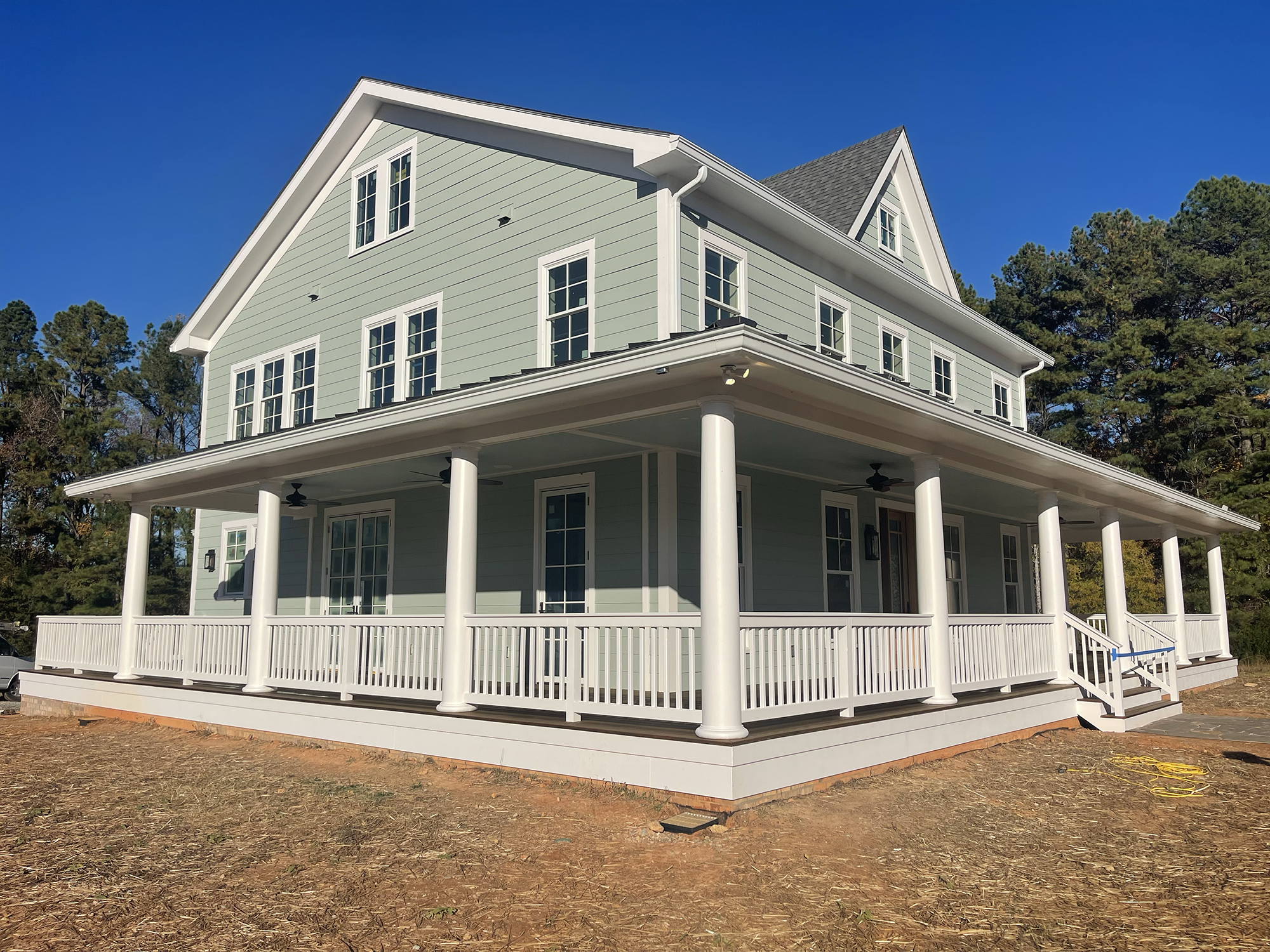 A new construction home in Hurdle Mills - side view. A two-story house with a 1500 square feet covered porch.