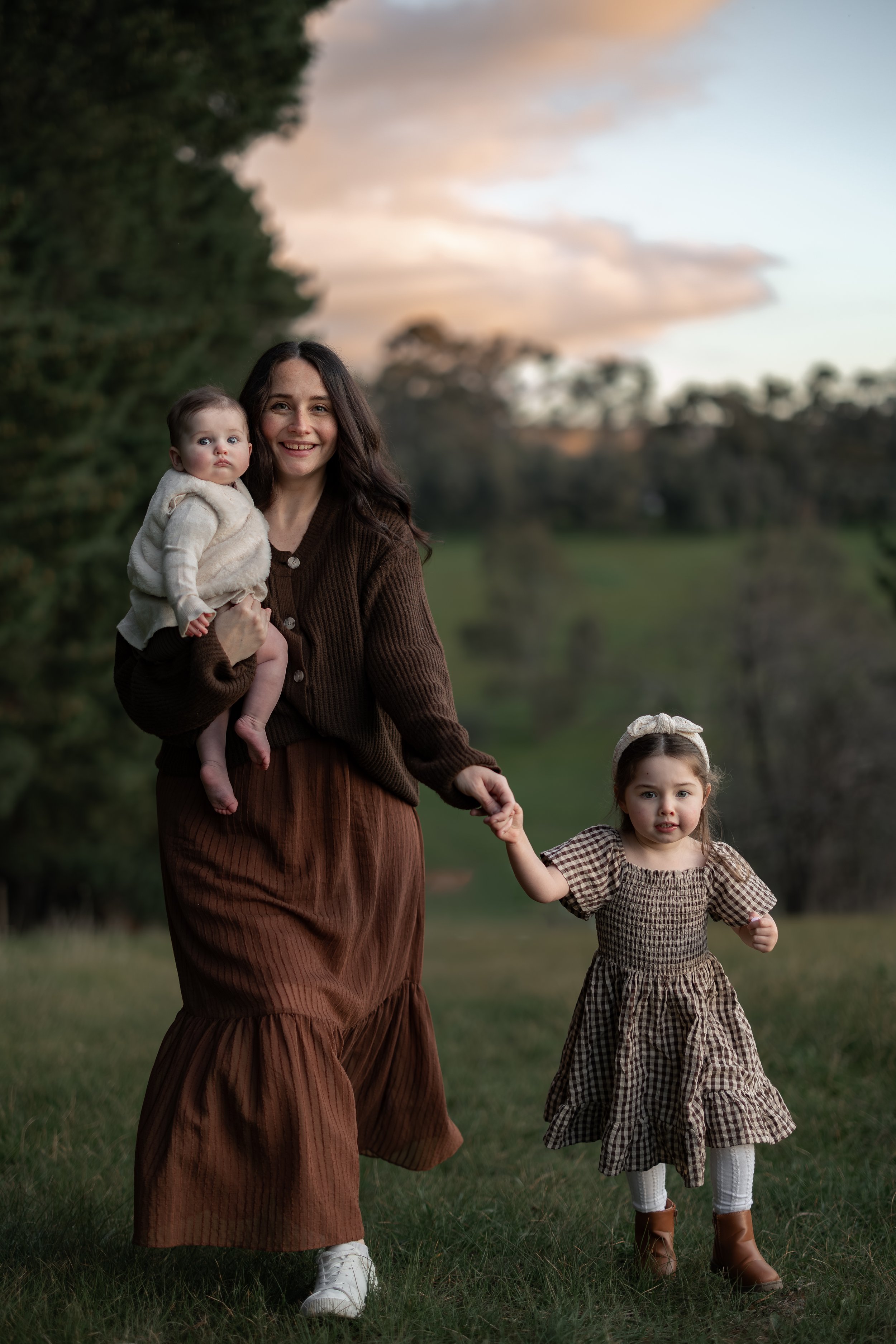Mother walking with two young children during an outdoor family photography session in Adelaide.