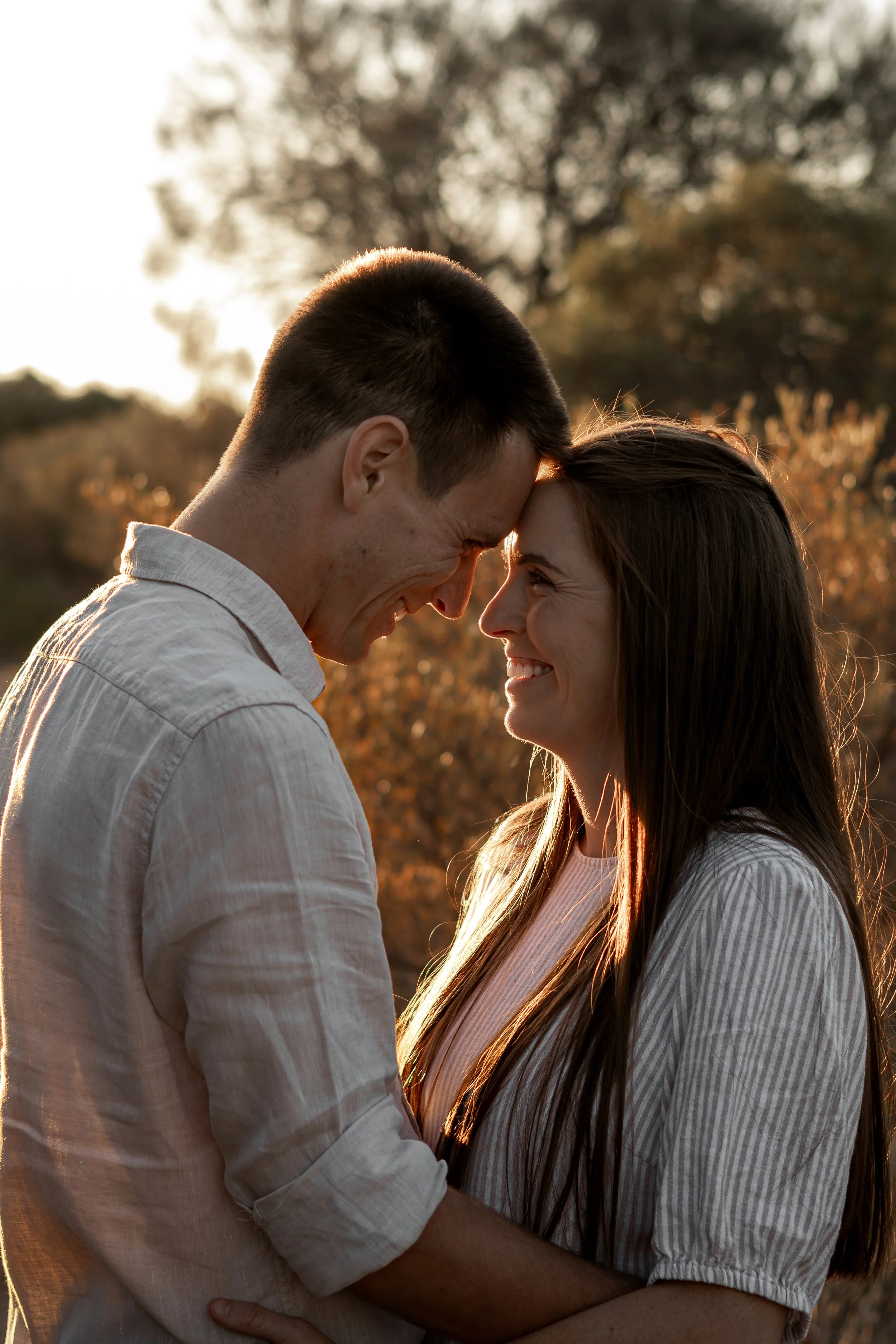 Couple embracing during golden hour couples photography session in Adelaide.