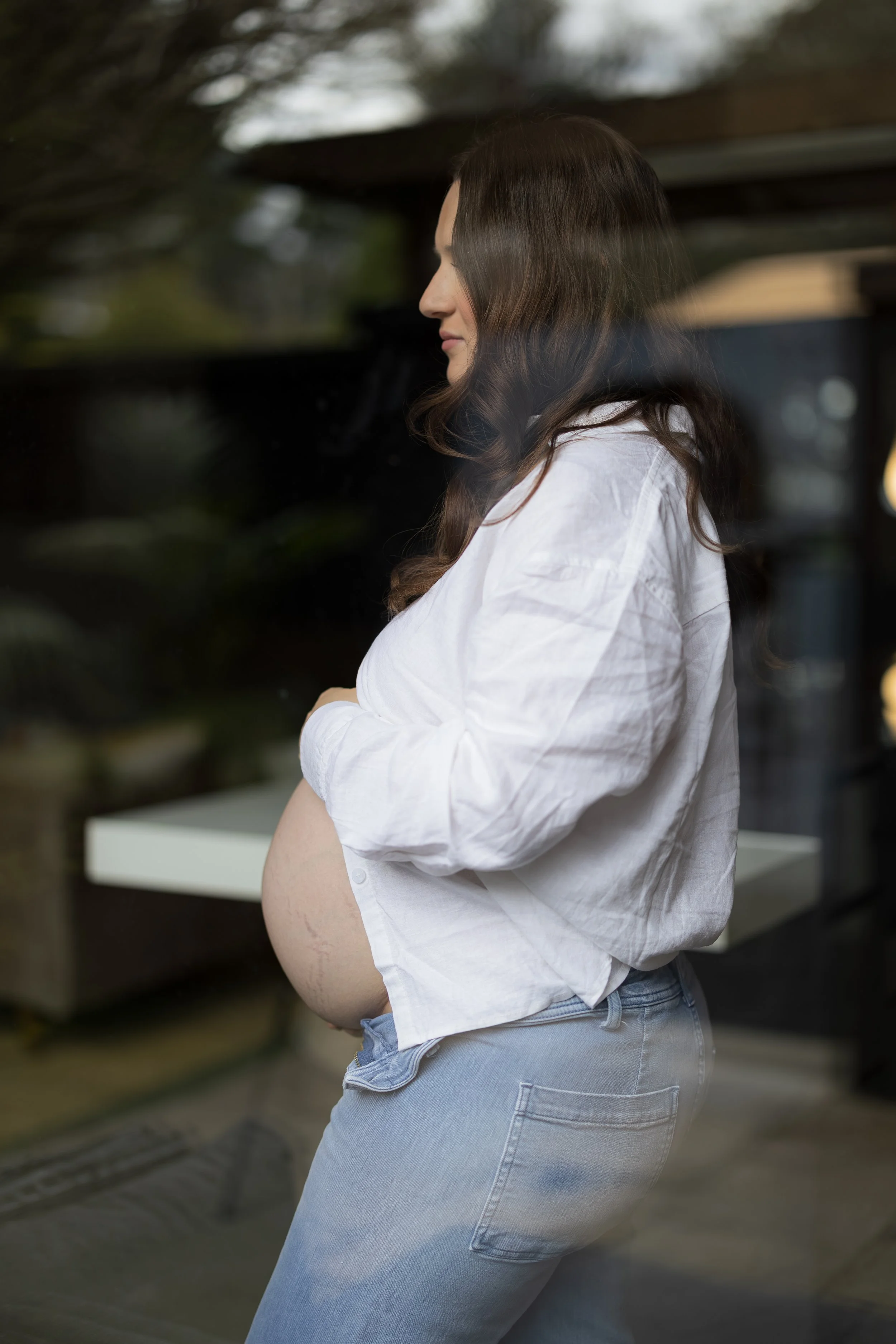 Pregnant woman in a white shirt during an Adelaide maternity photography session.