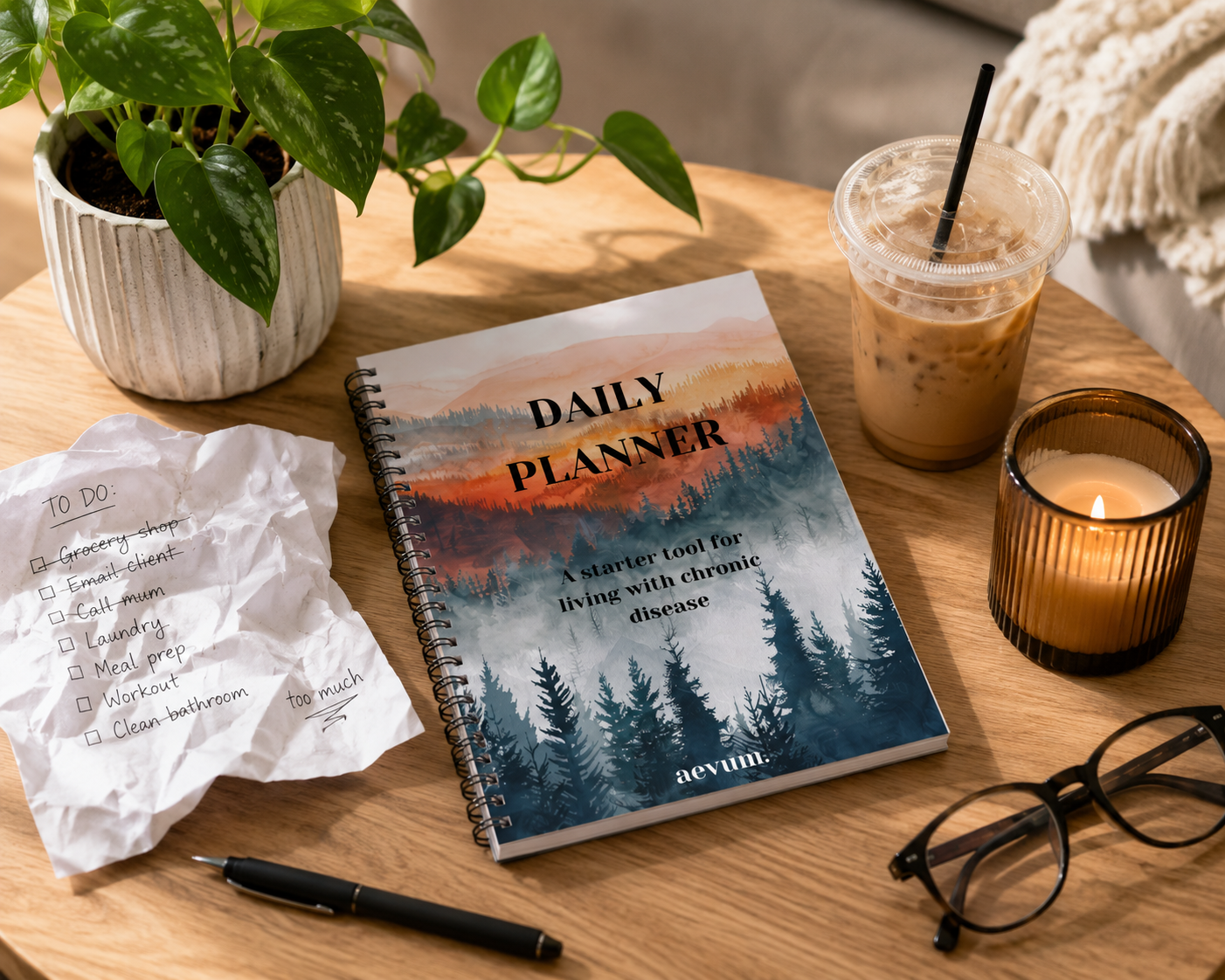 image of daily planner on table with candle, crumpled up task list and plant