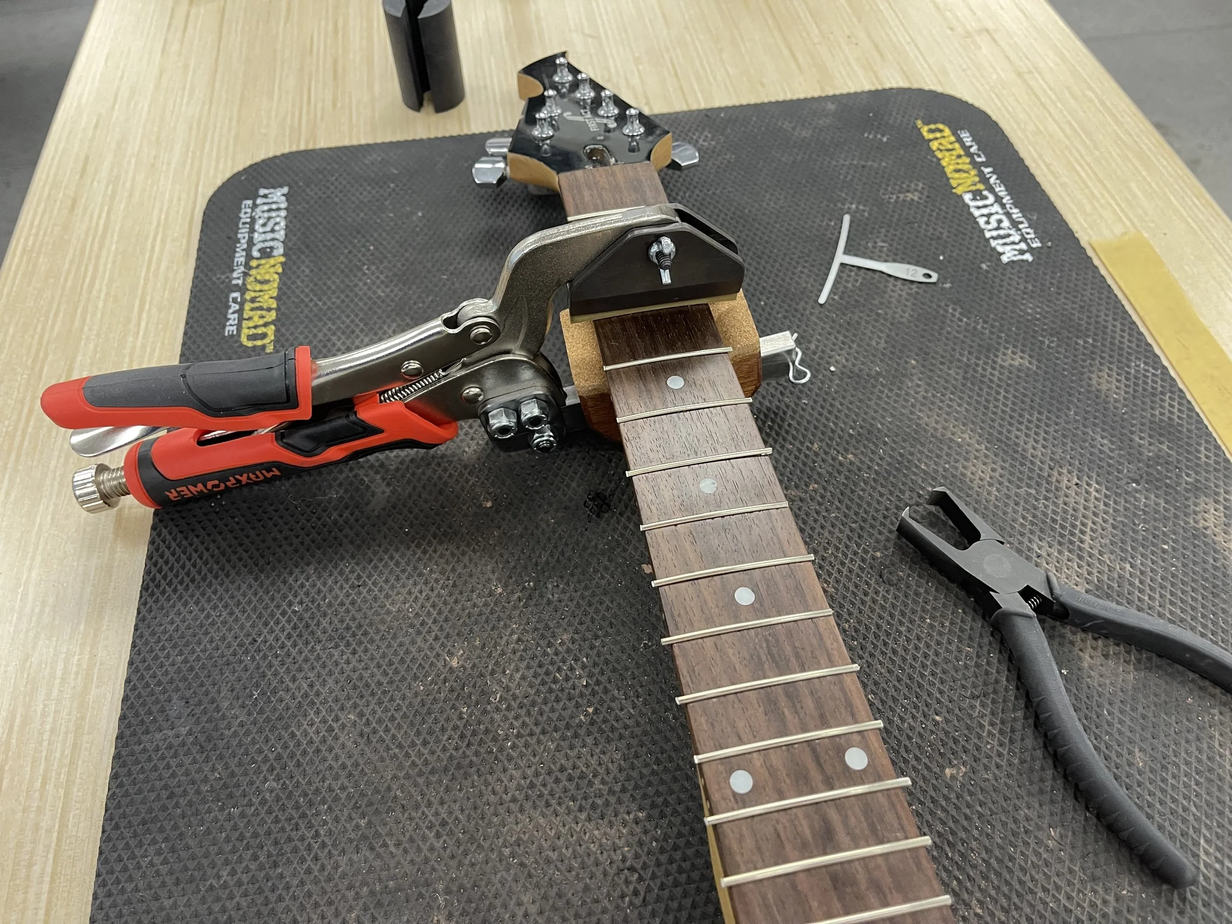 Refret- Clapping the frets in the fretboard.