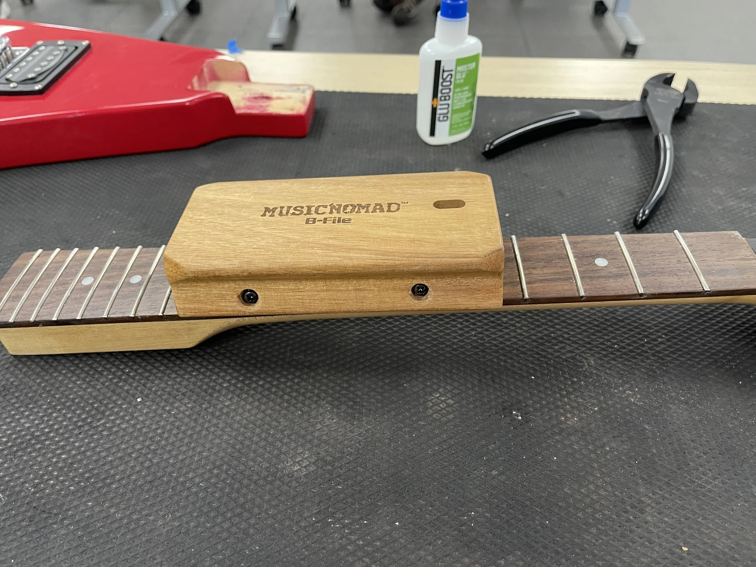 Refret- Sanding the fret ends.