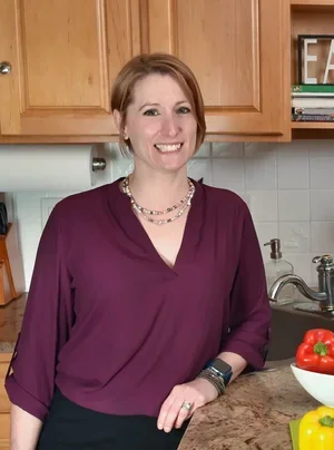 Louisa O'Grady, registered dietitian – nutritionist, certified diabetes educator and certified integrative and functional nutrition practitioner, smiling wearing a burgundy blouse and a beaded necklace