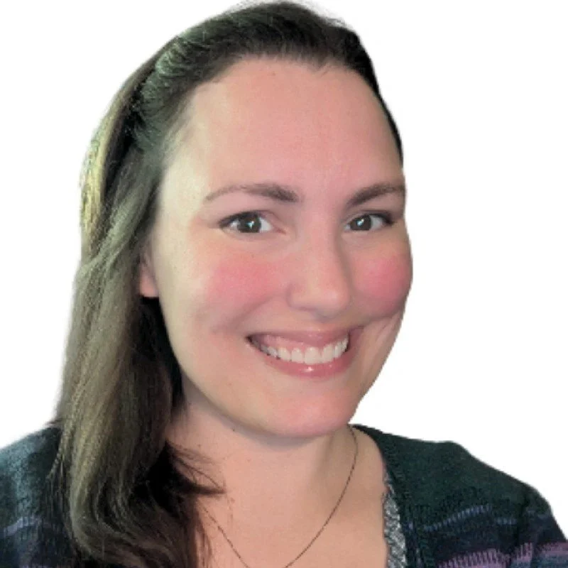 Katherine Housh, registered nurse, smiling in a teal and dark blue patterned cardigan top against a white backdrop