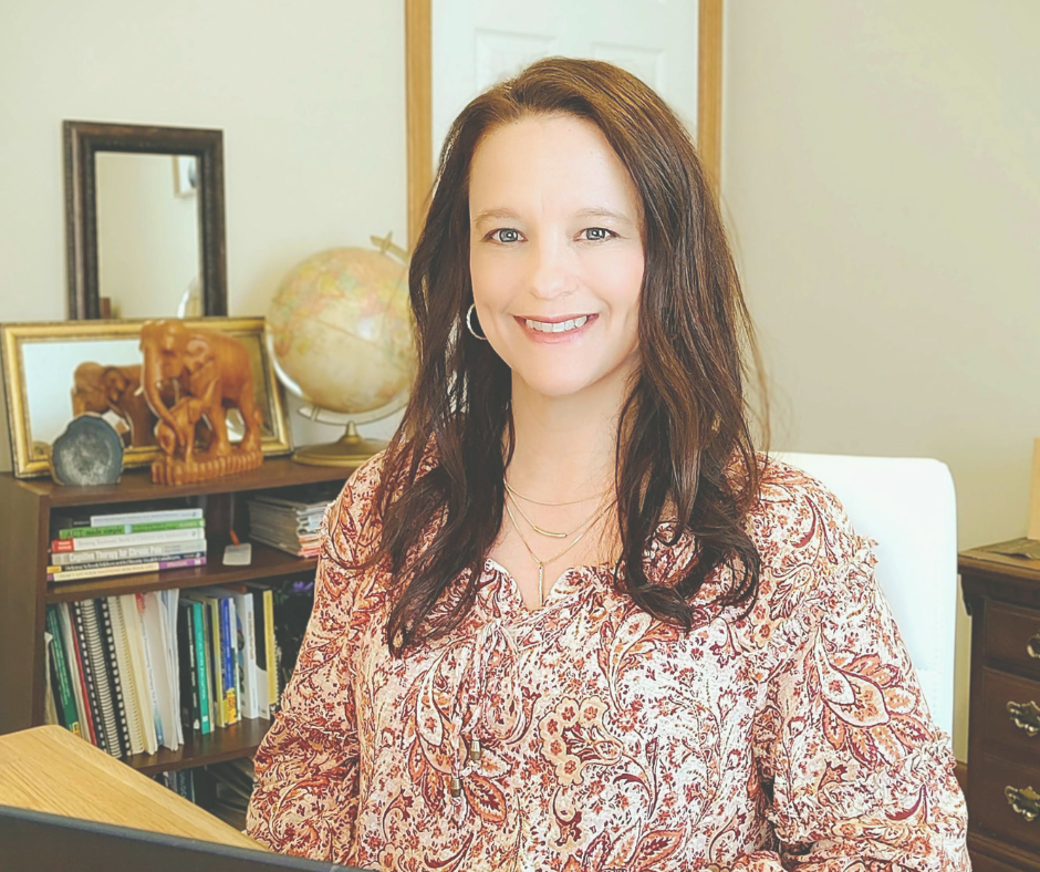 Michelle McKinzie, Licensed Clinical Social Worker, smiling in a patterned blouse seated in an office