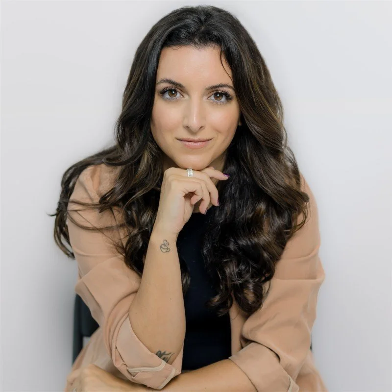Gabrielle Juliano-Villani, Licensed Clinical Social Worker, smiling in a tan blazer top against a solid light backdrop