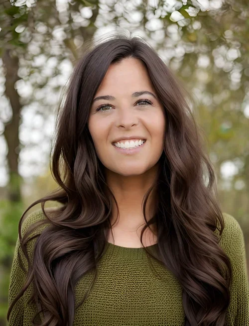 Amanda Whitehouse, Licensed Psychologist, smiling in an olive green sweater in front of an outdoor tree backdrop