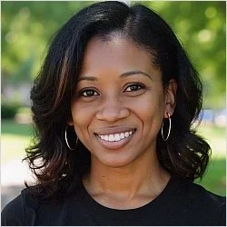 Kamilah Jones, Licensed Professional Counselor and Certified Rehabilitation Counselor, smiling wearing a black top and hoop earrings