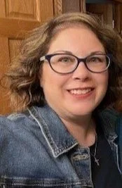 Close-up portrait of Tiffany Quicke, Respiratory Therapist, Certified Asthma Educator, and Lung Health Navigator, smiling in a denim jacket