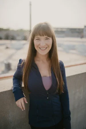 Rachel Smith, Master of Science and Certified Personal Trainer, smiling wearing a navy blue zip-up jacket outdoors