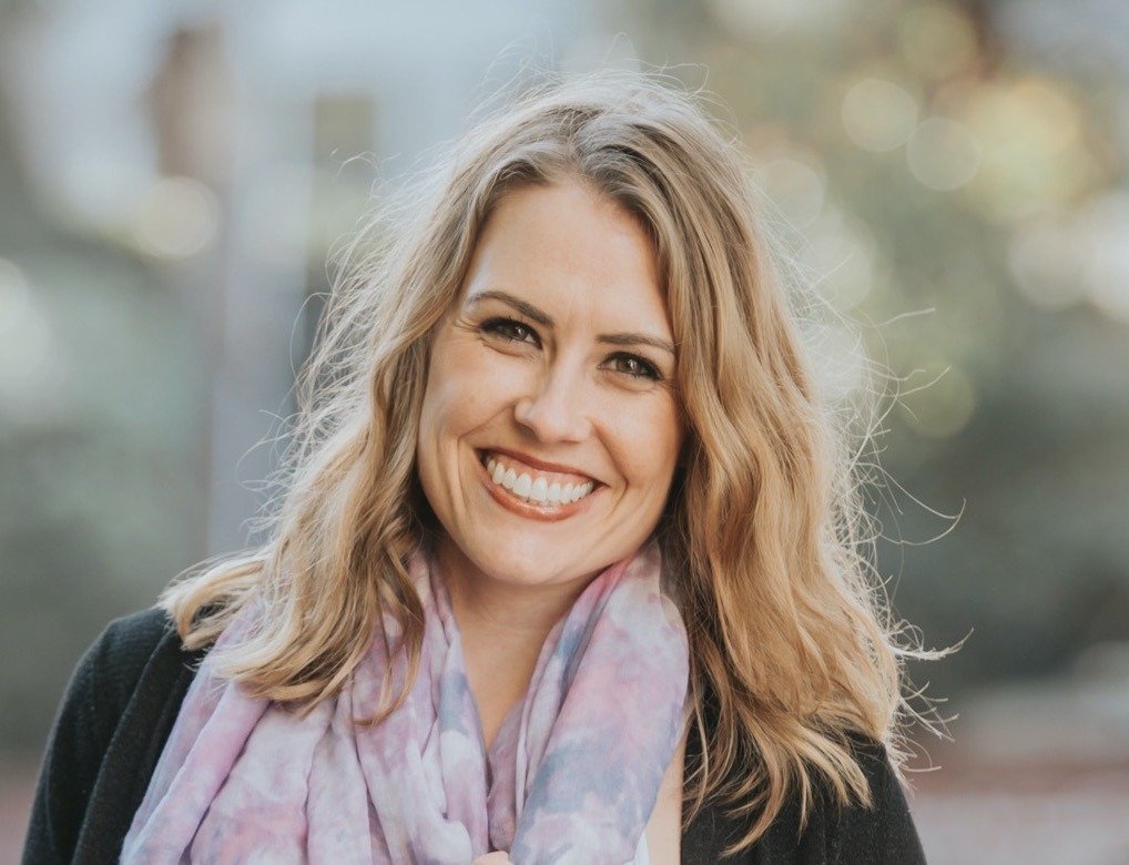 Dr. Hannah Khoddam, Licensed Clinical Psychologist, smiling in a light patterned scarf and dark jacket outdoors